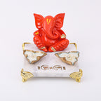 Orange Ganesha With Marble Choki And Candles