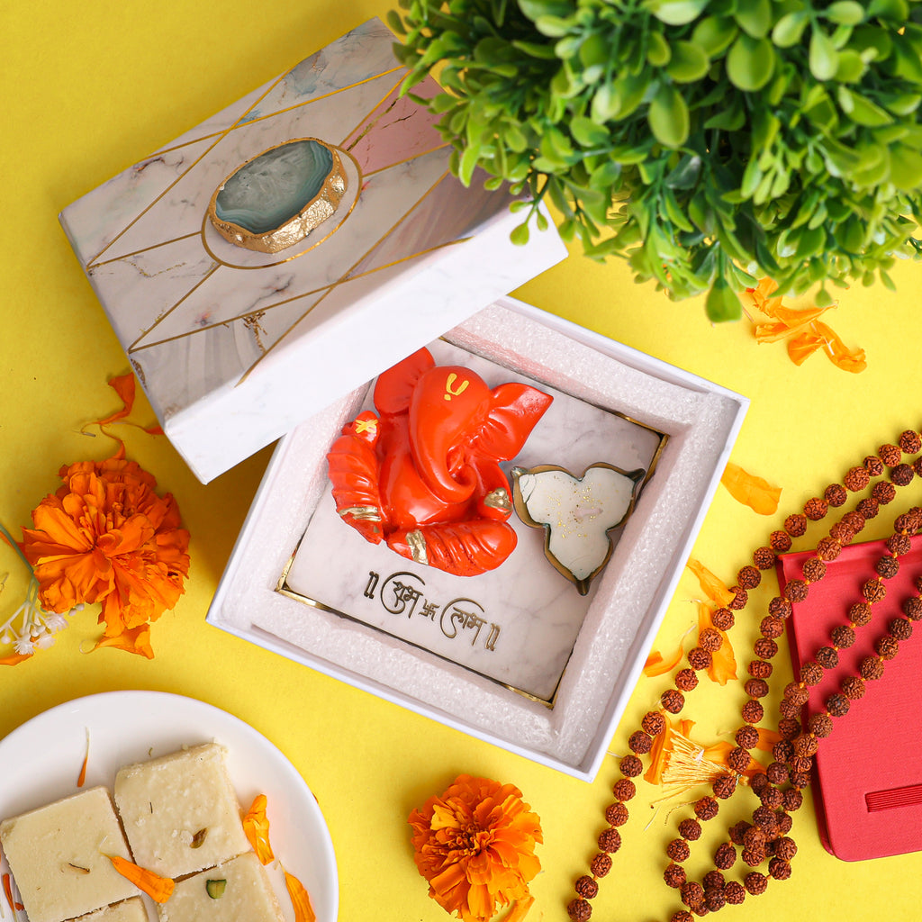 Orange Ganesha With Marble Choki And Candles